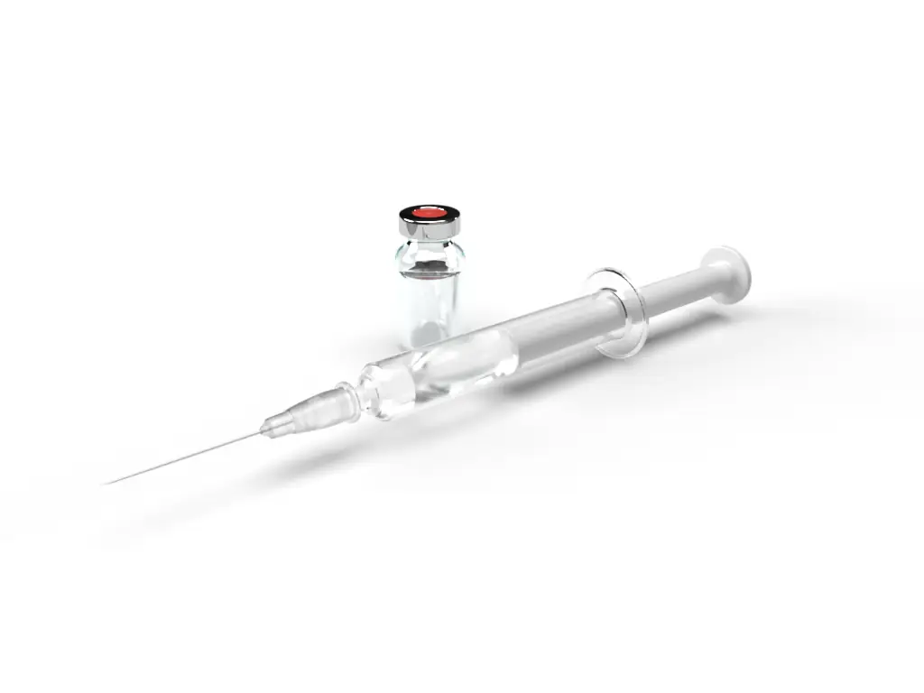 Studio photograph of a syringe on a black ground.